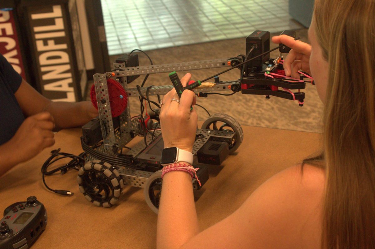 Mirka, an adventures in vex robotics camper from Columbia, South Carolina, fixes her robot before the match. Although Mirka hasn't had an experience in robotics before this camp, she has used this opportunity to learn more about engineering. "I'm interested in engineering, so I thought it would be like a good camp to learn more about, I guess like the riots and how things can work."